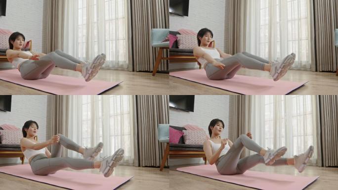 年轻女子在家健身身体塑性锻炼身体练习瑜伽
