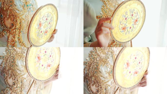 中式新娘手里的圆扇