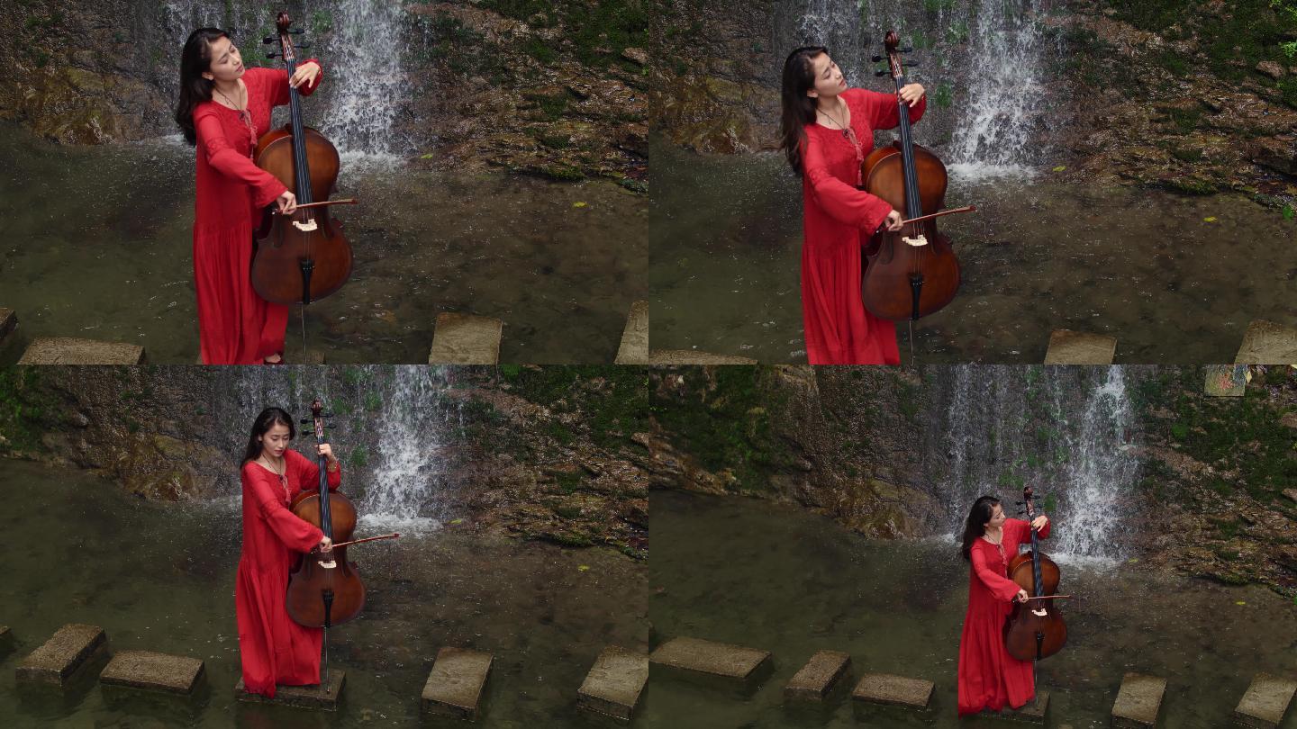 红衣女孩在瀑布前拉大提琴