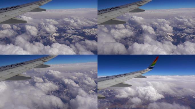 飞机飞行中窗外群山云层景色