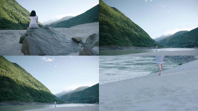 怒江大山边沙滩上行走在沙子上写字看大山