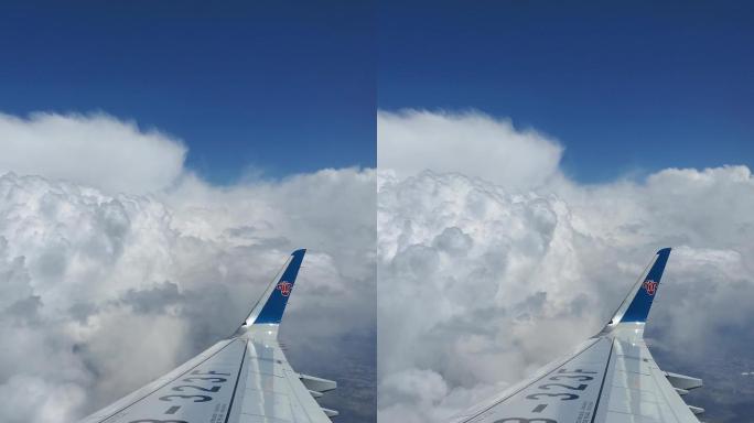 竖屏 飞机飞行中的机翼与天空云朵蓝天白云