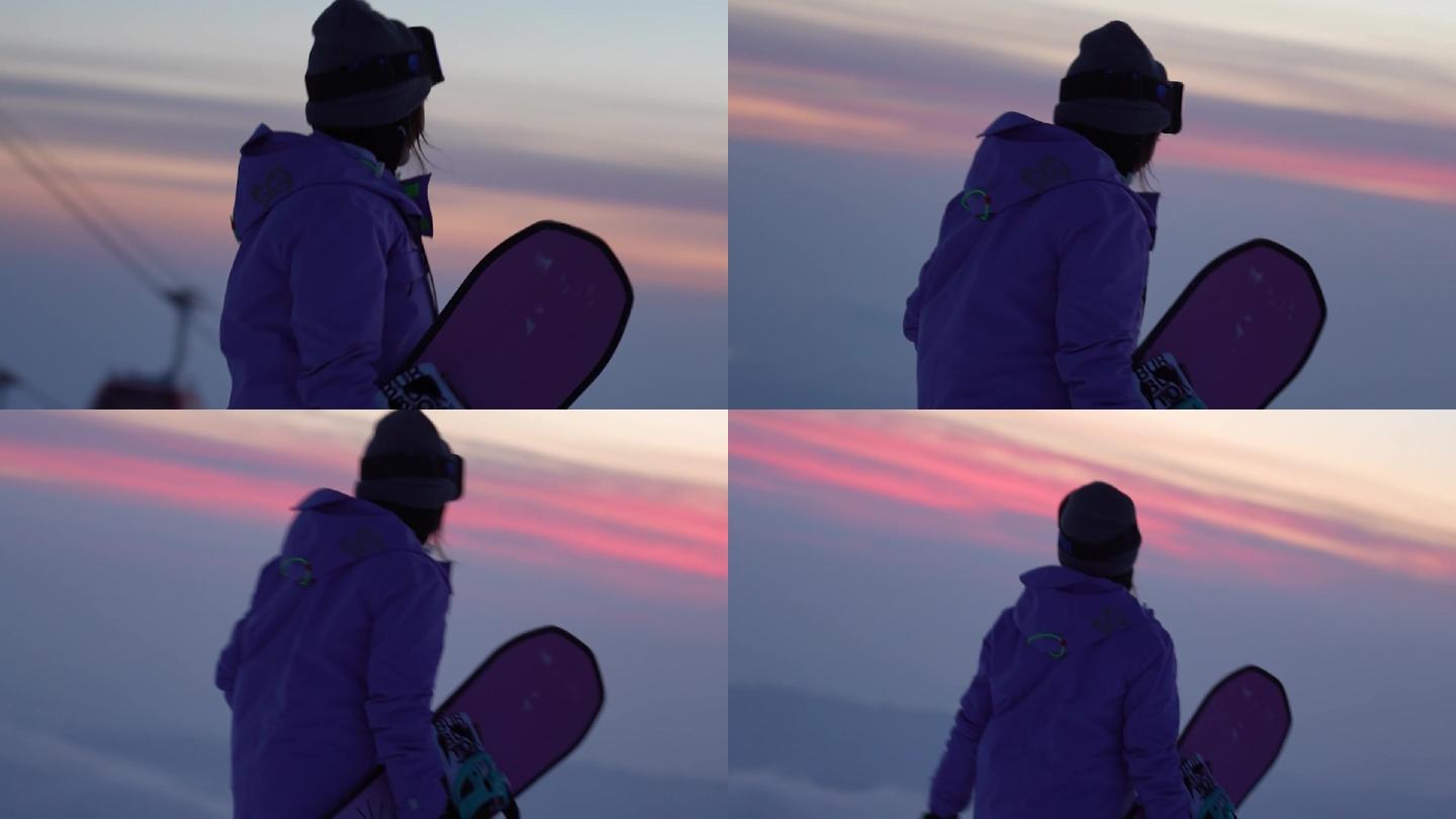 滑雪的女孩在山顶看晚霞