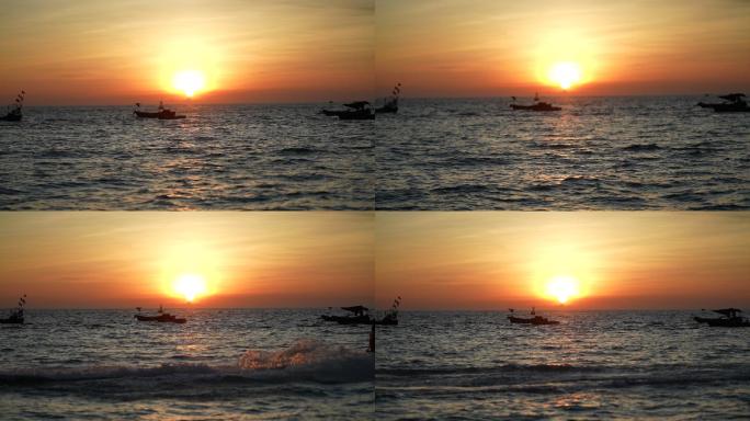 海边夕阳日落渔船和载冲锋艇的游客