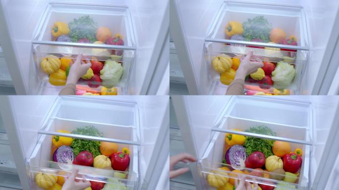 打开冰箱抽屉拿起苹果水果