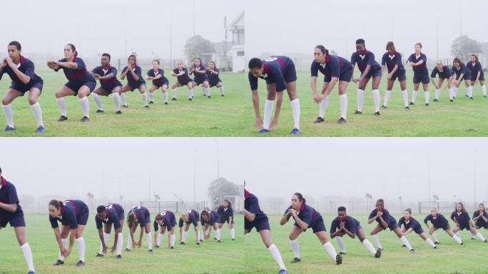 一组女子高中橄榄球运动员在球场上训练