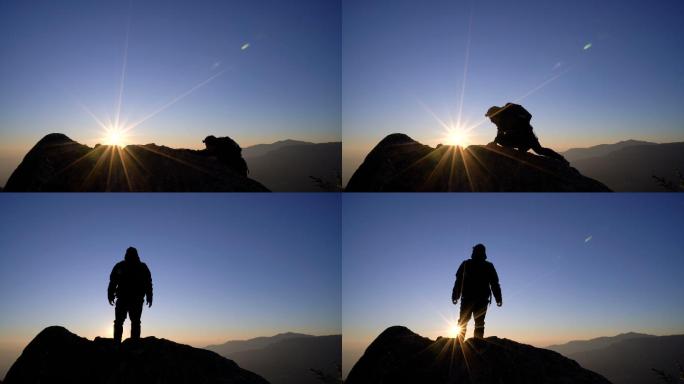 男子站在山上，向日出的天空举起双臂。