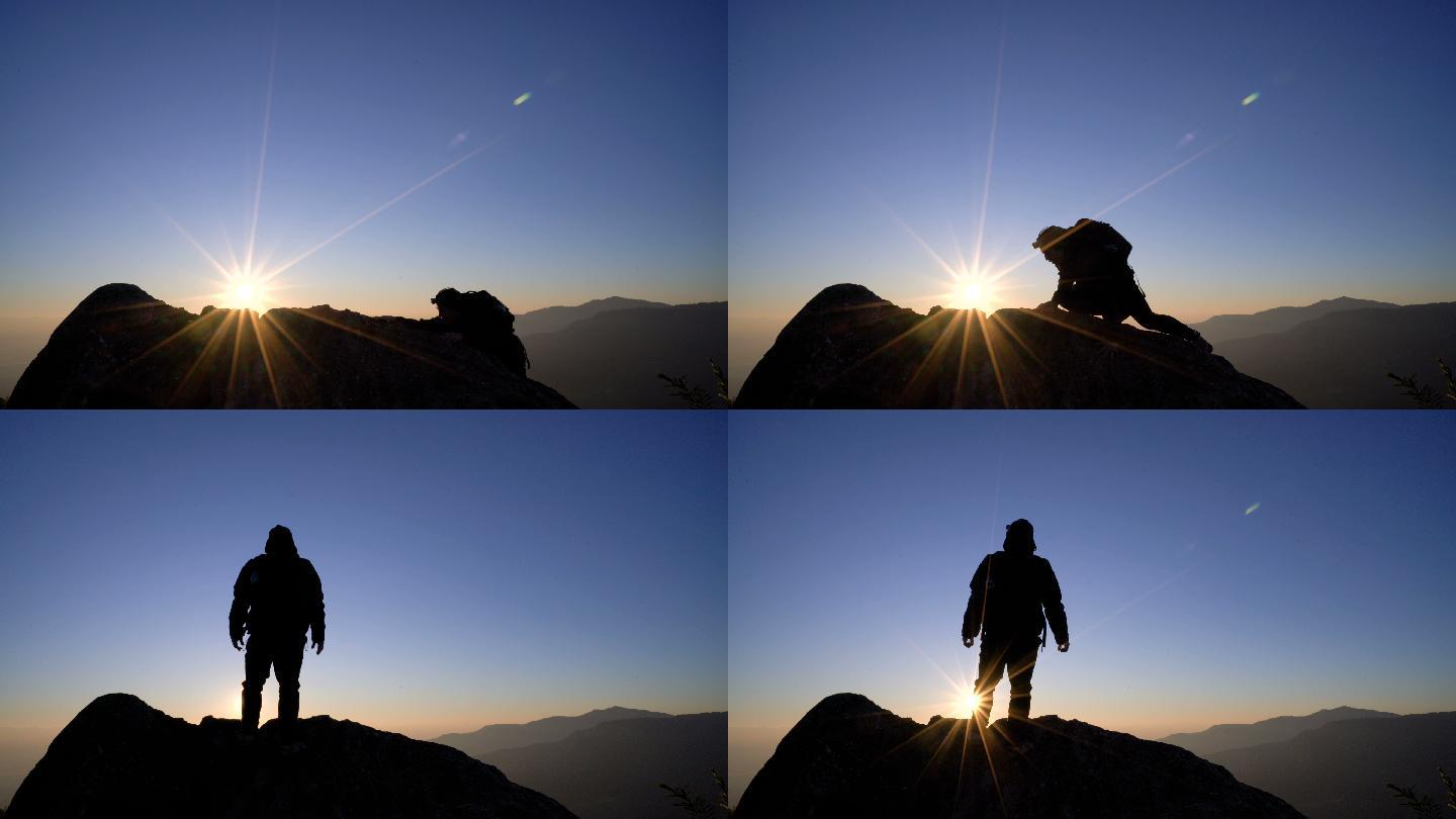 男子站在山上，向日出的天空举起双臂。