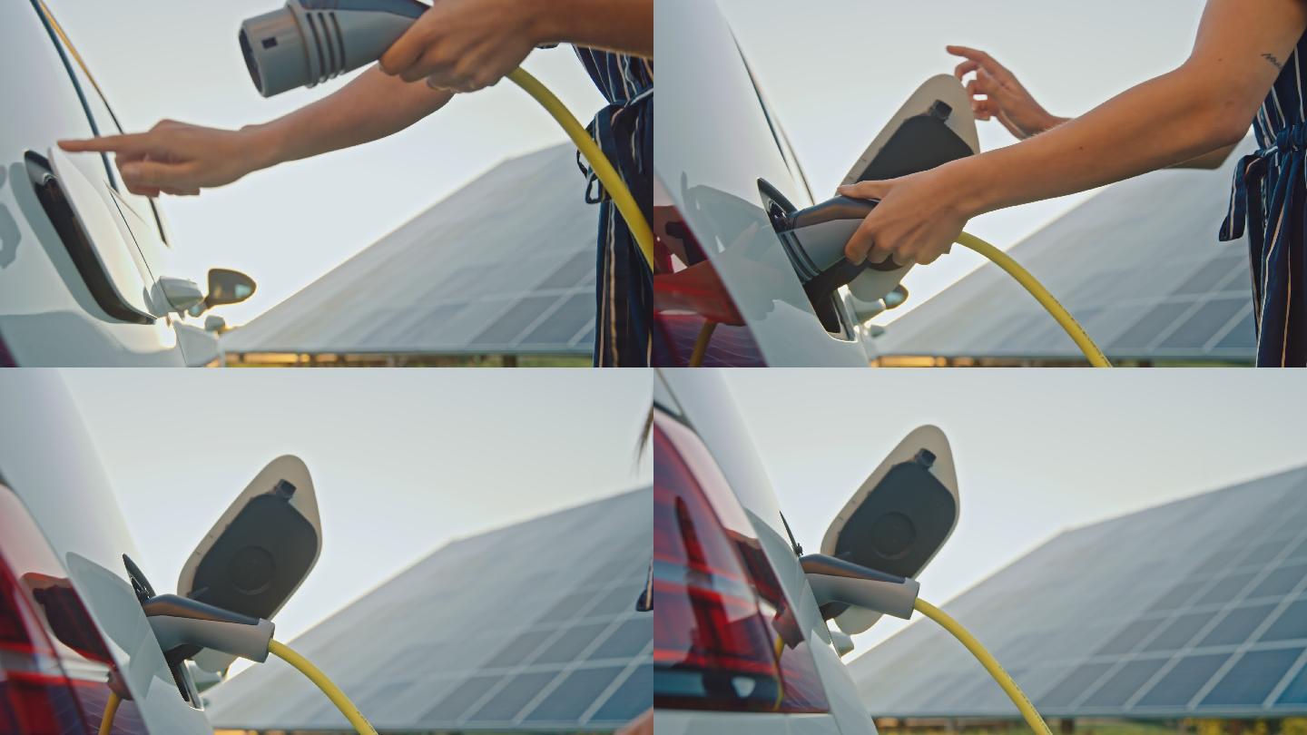 女士在太阳能驱动的电动汽车充电站为她的汽