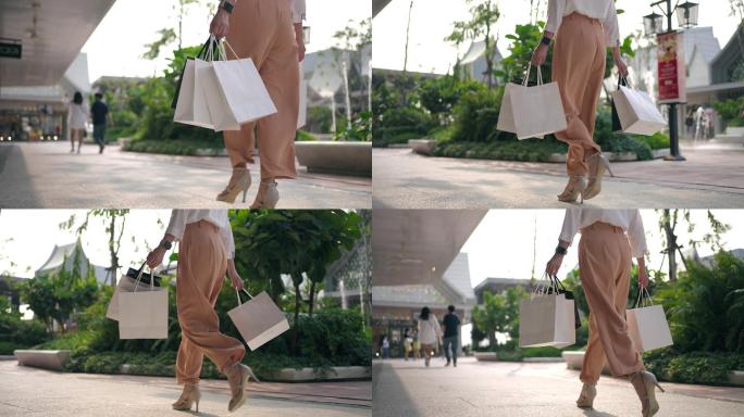 女性步行购物袋的特写腿
