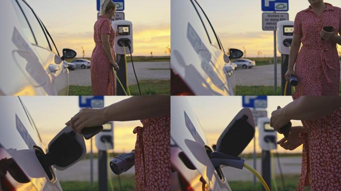 女士在电动汽车充电站为她的电动汽车充电