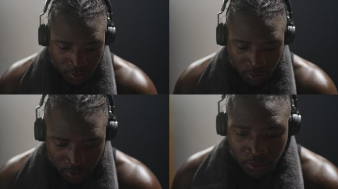 男子在拳击俱乐部更衣室使用耳机的4k视频