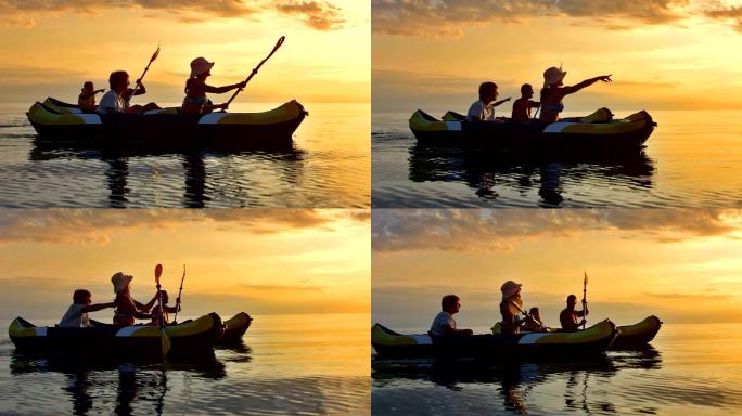 家庭在日落时玩皮划艇