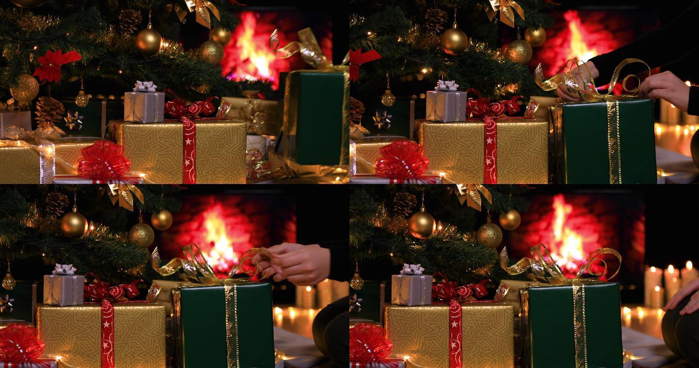 一名妇女将礼物放在壁炉旁的圣诞树下