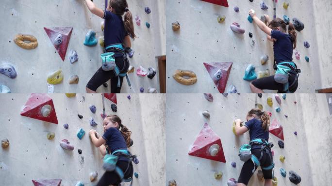 女孩在攀岩馆爬墙。