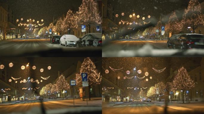 中景车在雪地里开着灯沿着主街行驶