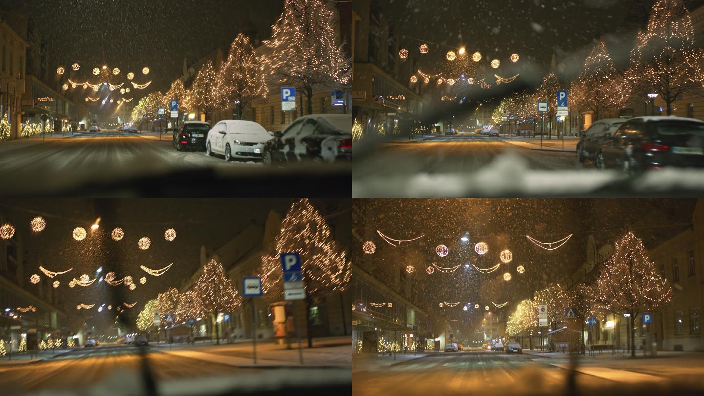 中景车在雪地里开着灯沿着主街行驶
