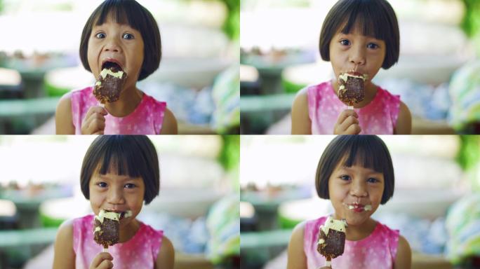 可爱的女孩正在吃巧克力冰淇淋零食