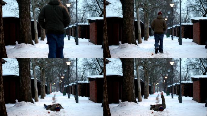 年轻的男性摔倒在雪地上