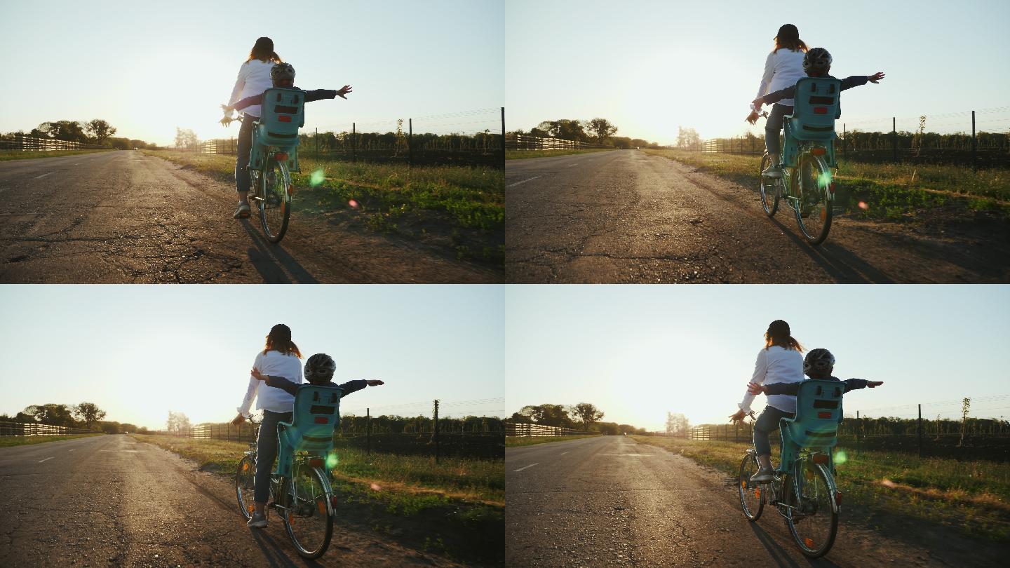 妈妈和她的小儿子正在路上骑自行车