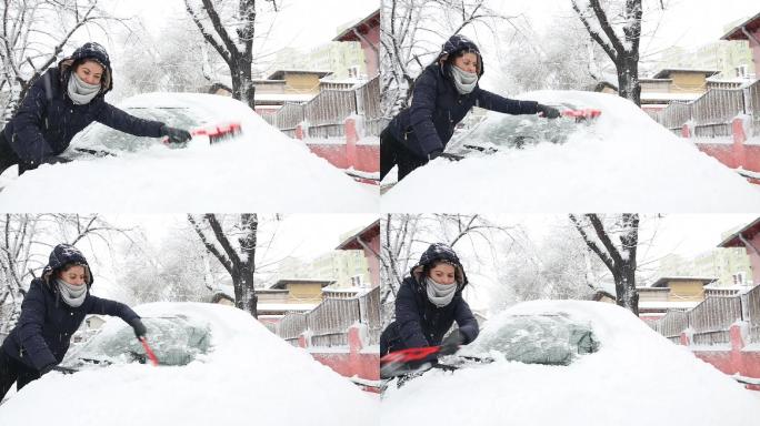 一位年轻女子正在刷去汽车上的积雪。