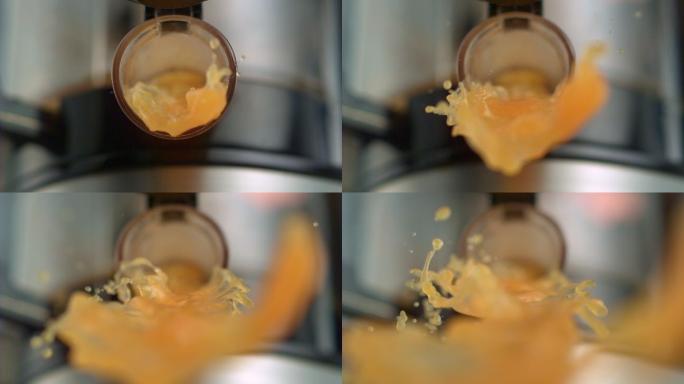 橙汁从榨汁机中倒出