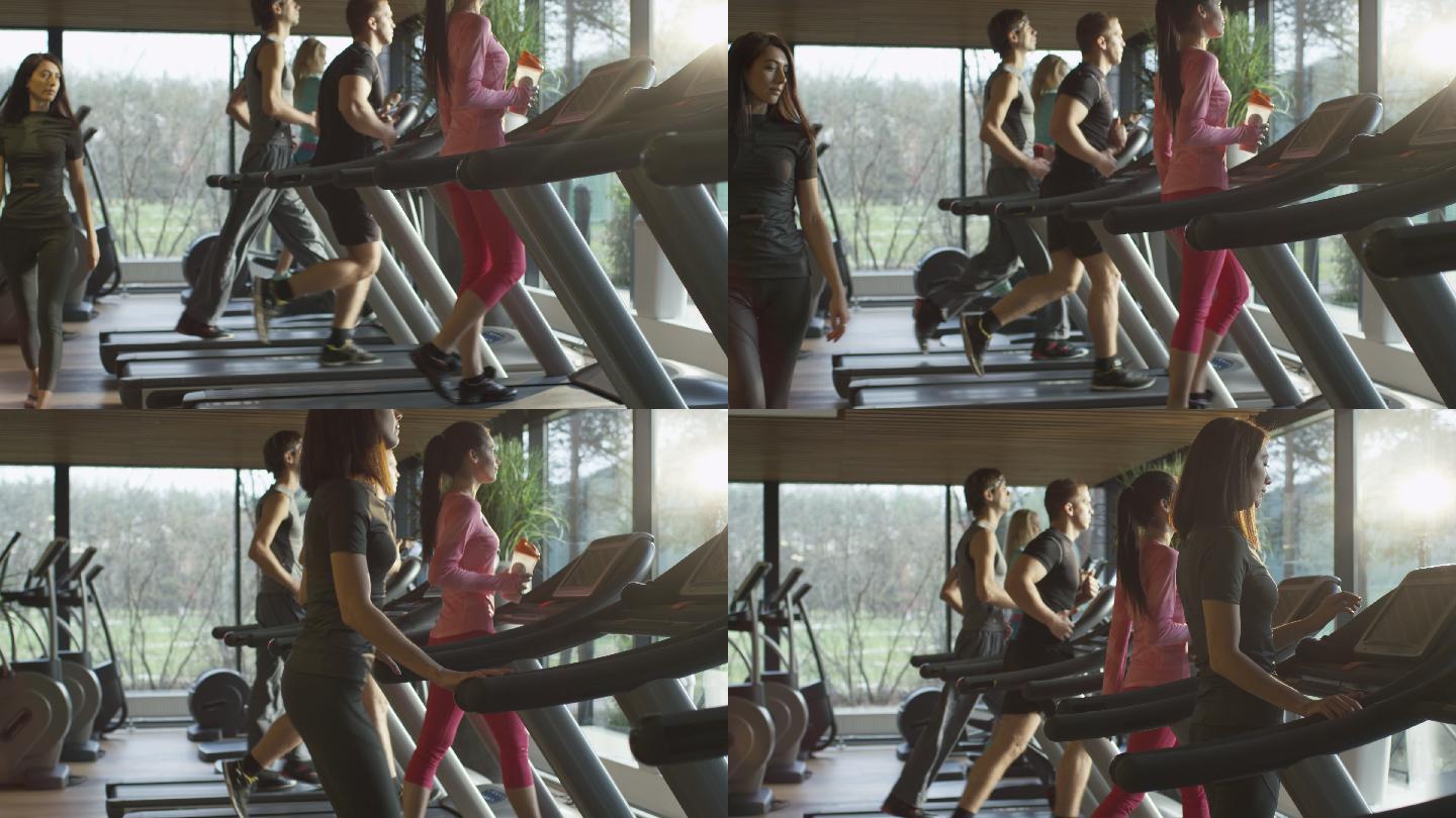 年轻的运动男女在运动健身房的跑步机上锻炼