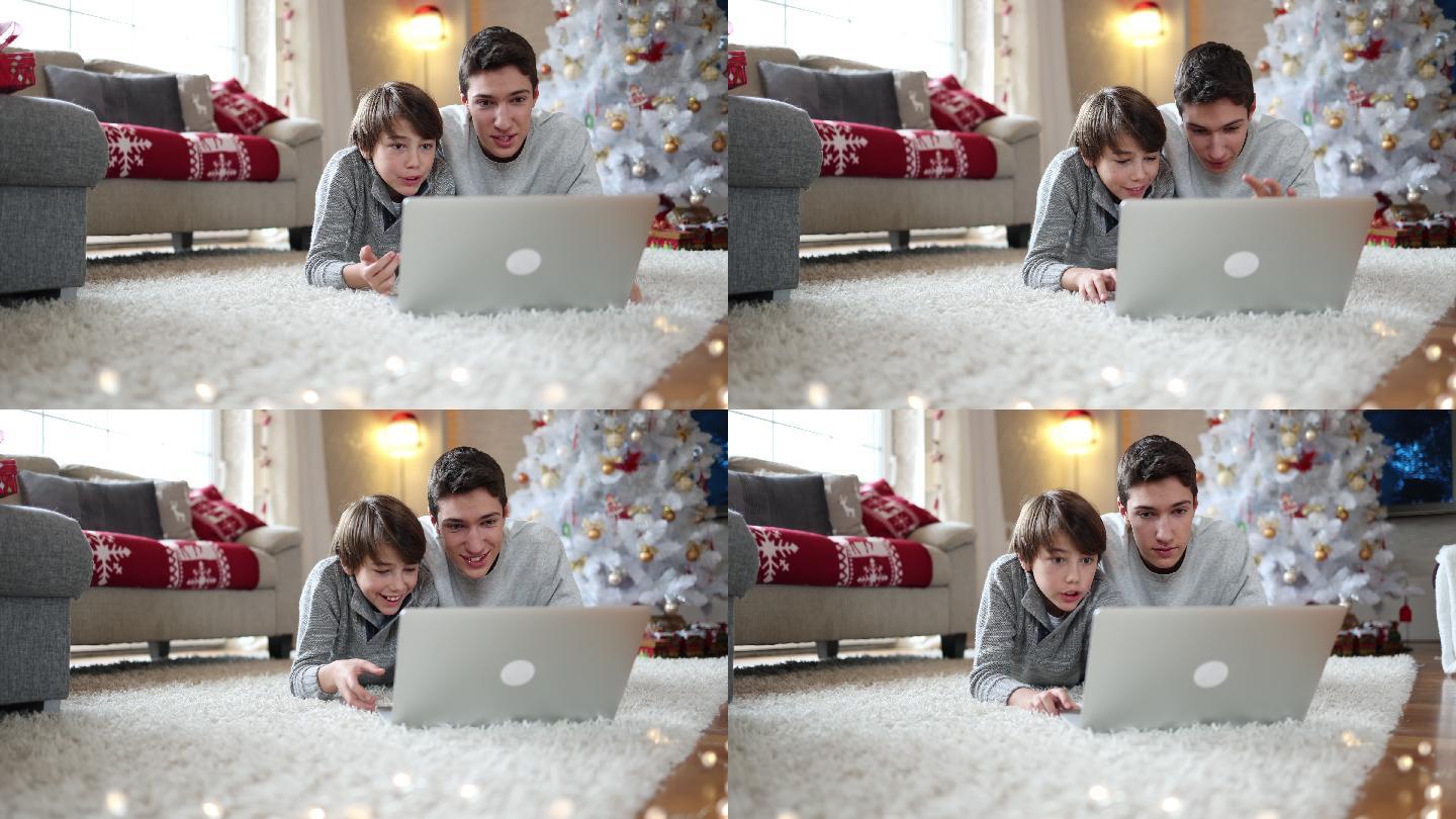 两兄弟在圣诞节使用笔记本电脑