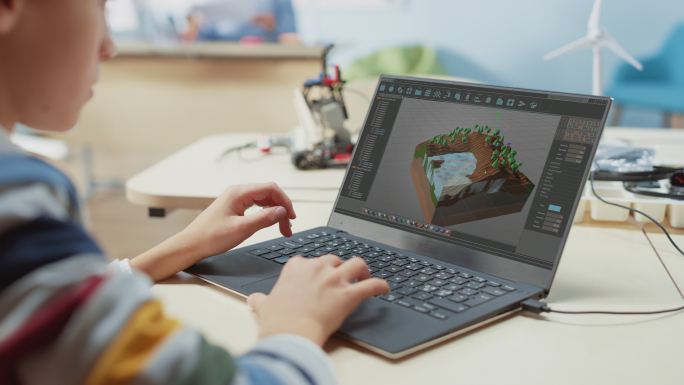 一个孩子使用笔记本电脑设计3D游戏