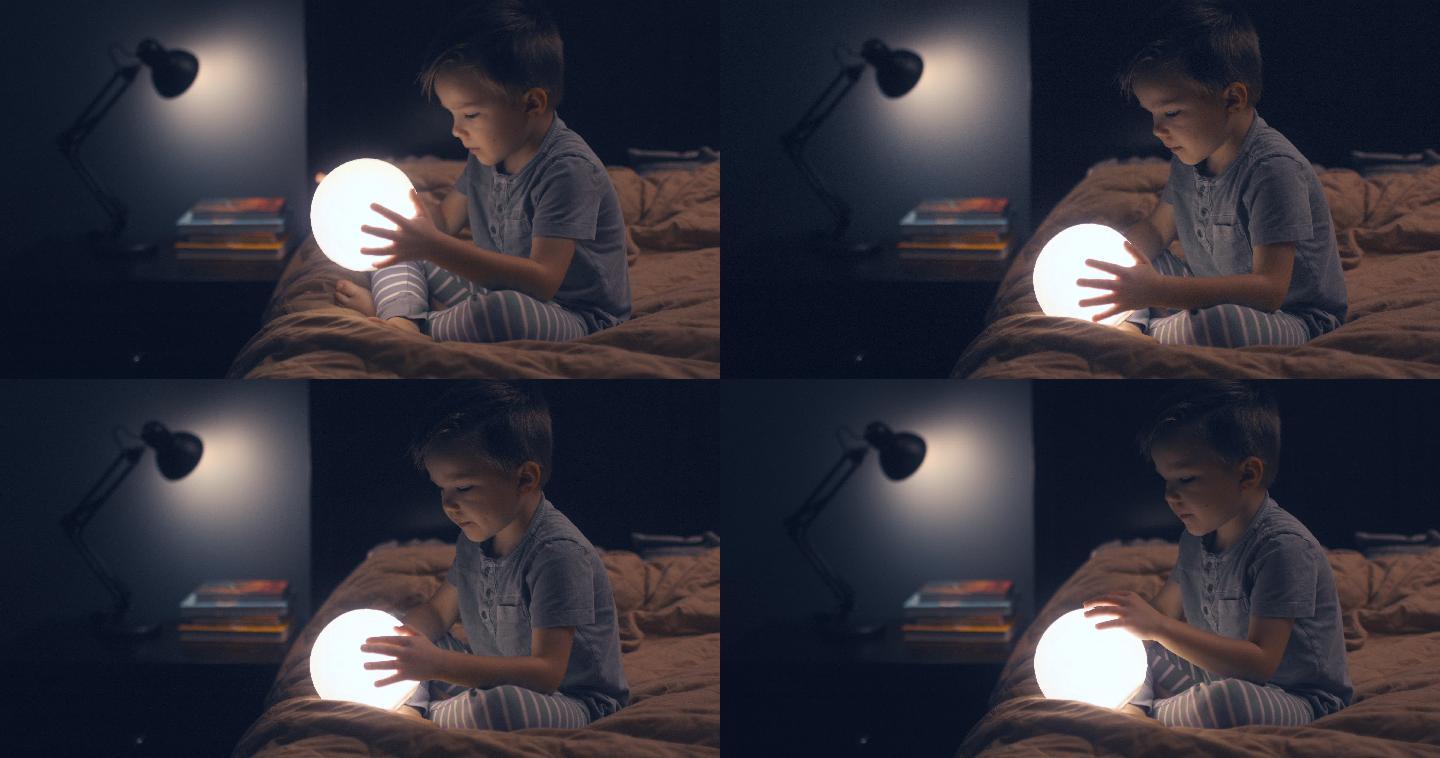 一个孩子坐在床上，手里拿着一轮明月。