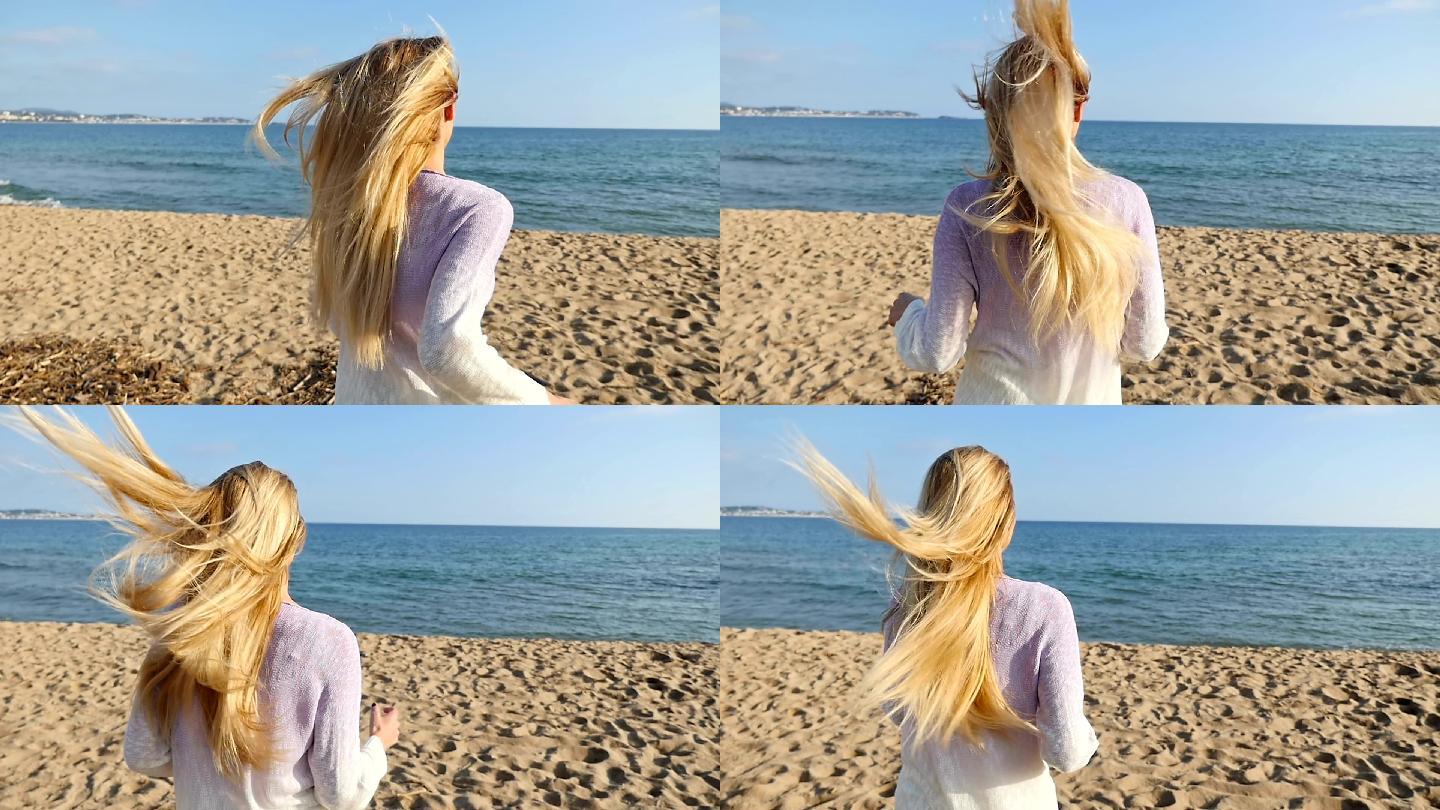 长发的年轻女子在海滩上跑步