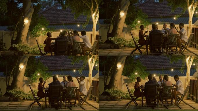一组年轻朋友在户外晚宴上举杯祝酒