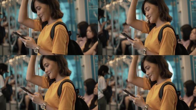 在地铁上使用智能手机的女人