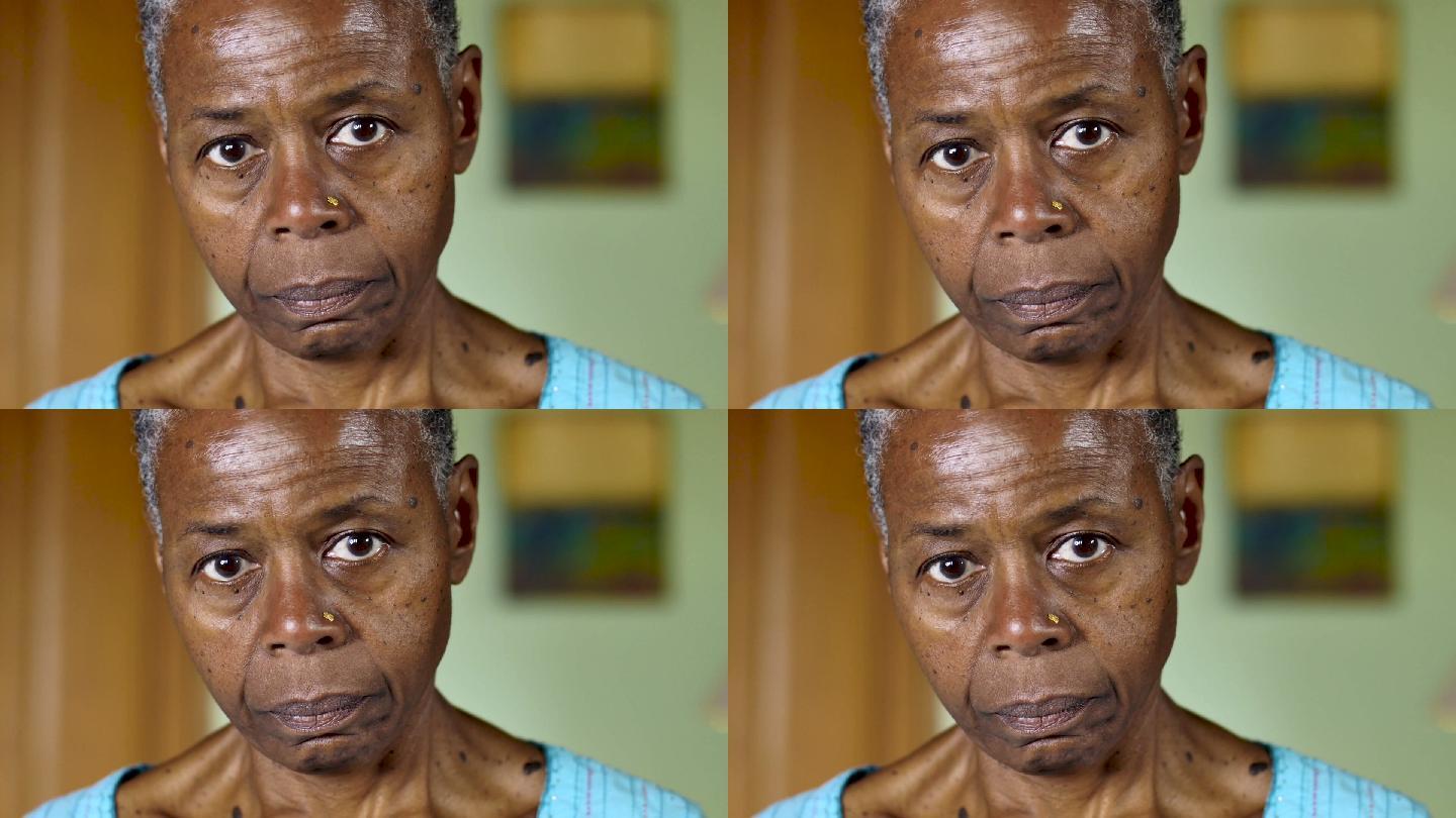 一位悲伤的老妇人看着相机的特写镜头