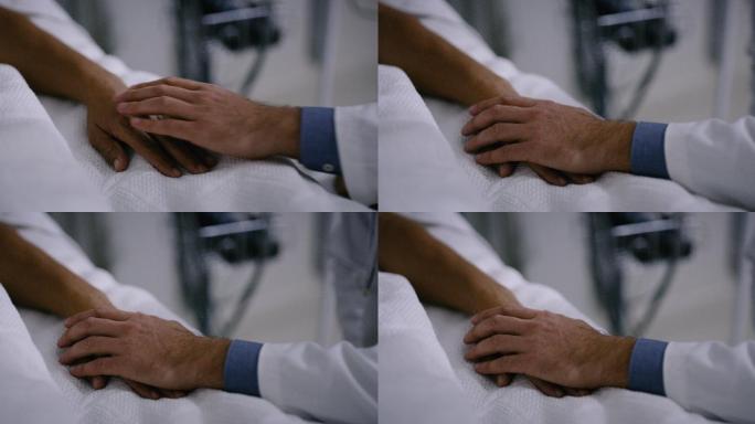 一个医生握住病人的手