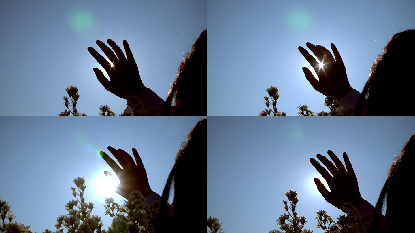 阳光穿过她的手和手指