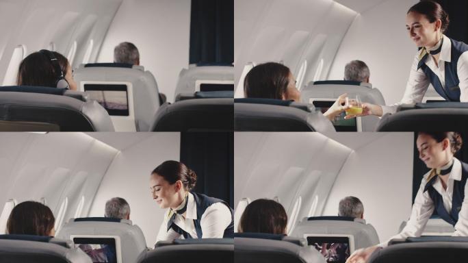空姐在飞机上为女商人提供午餐