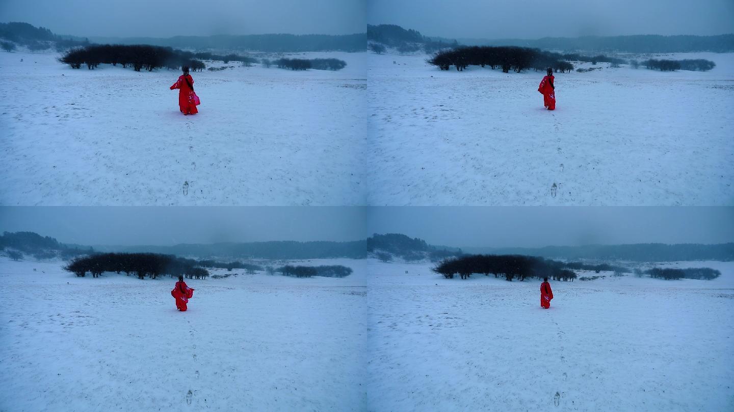 雪地身穿红色古装的美女渐行渐远