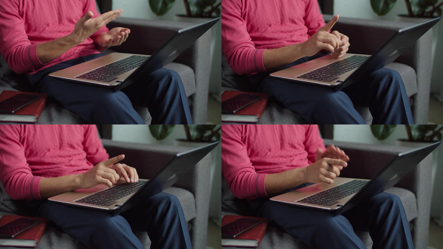 男子用手语通过笔记本电脑发送信息。