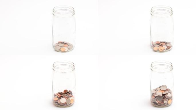 玻璃罐中的硬币财富积累积少成多金融理财