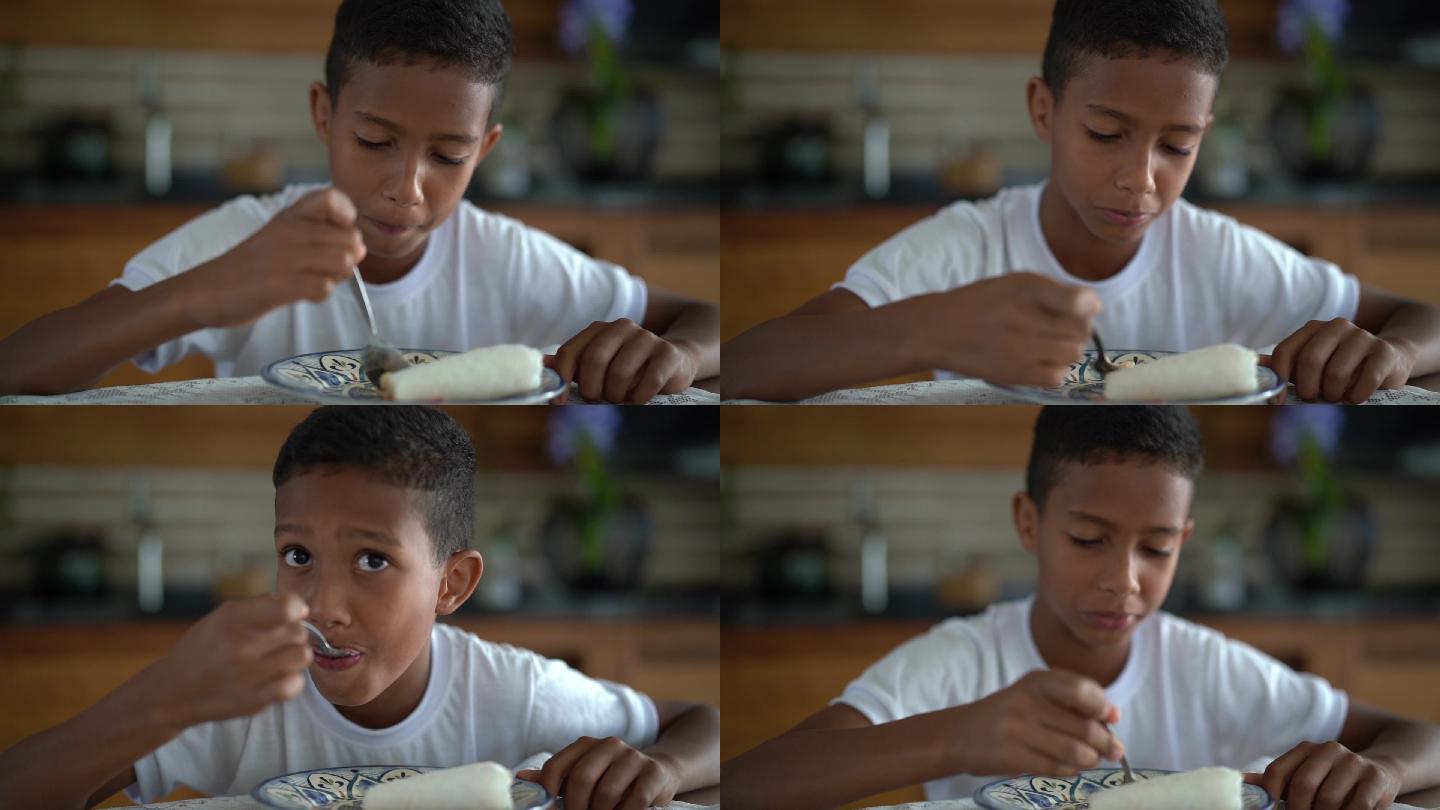 可爱的巴西男孩早餐吃木薯