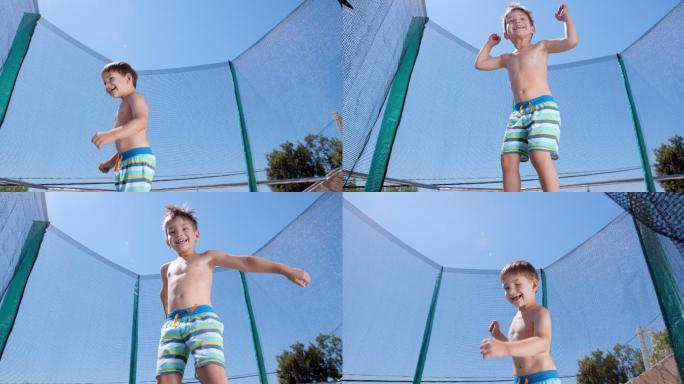 蹦床上跳跃的男孩跳跳床泳裤小朋友