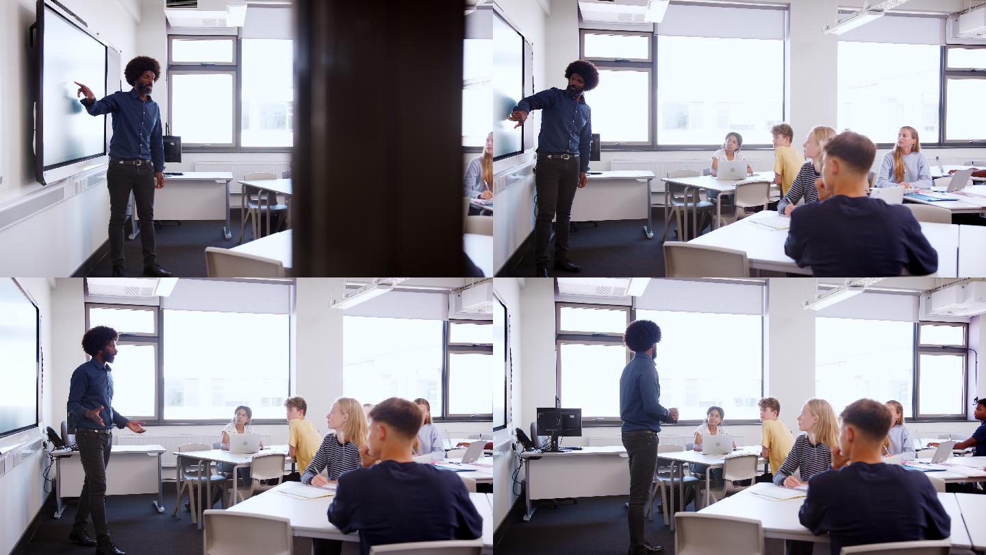 男高中教师站在互动白板旁，进行教学