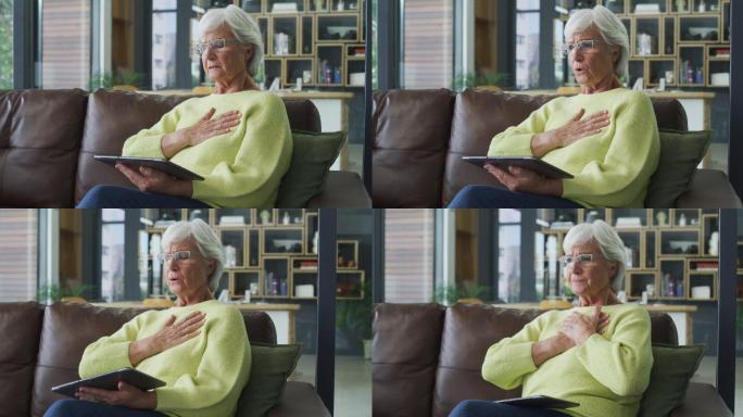 一名老年妇女在家使用数字平板电脑时胸痛