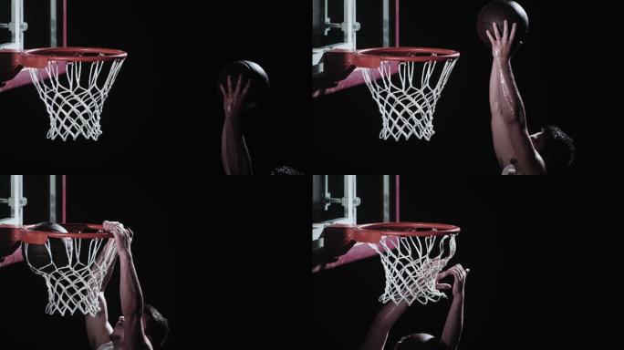 篮球运动员将球扣篮穿过篮筐的动作