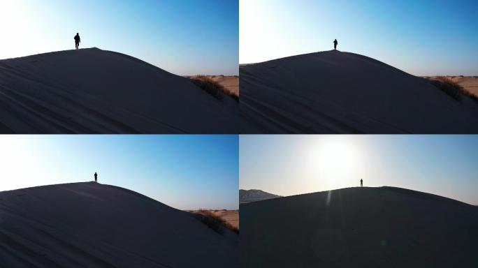 航拍沙漠夕阳下一个人剪影