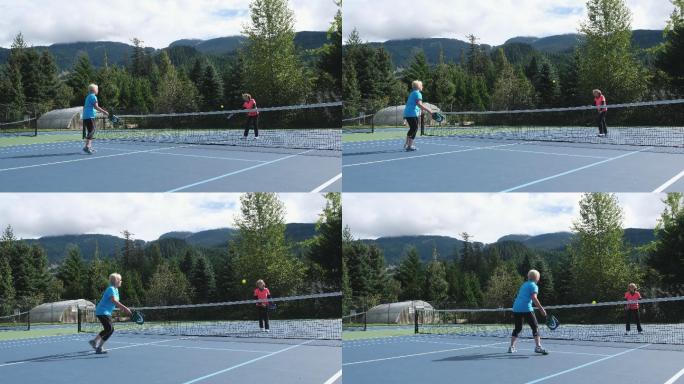 两名女子在网球场上打球