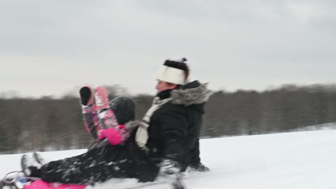 孙女和奶奶在雪山上玩冬季运动