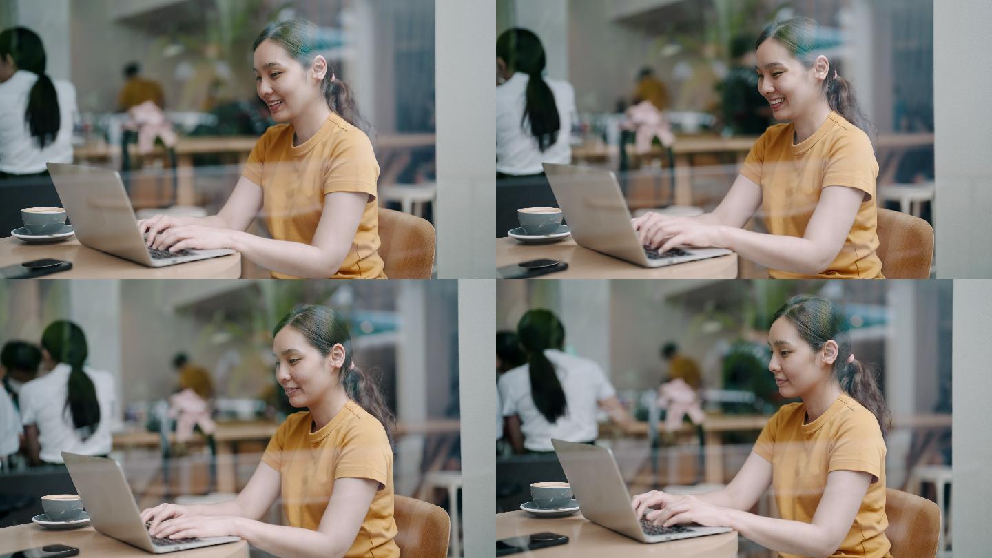 在咖啡馆使用笔记本电脑的女人