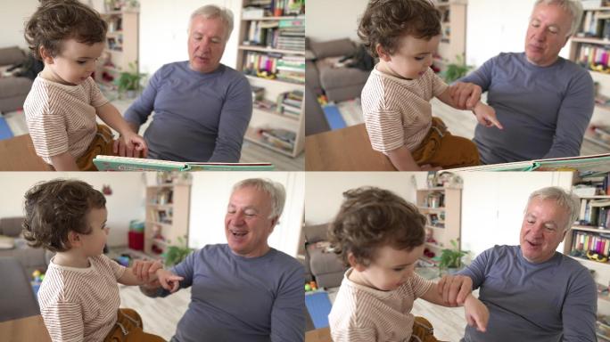 爷爷和蹒跚学步的孩子在家里一起看图画书